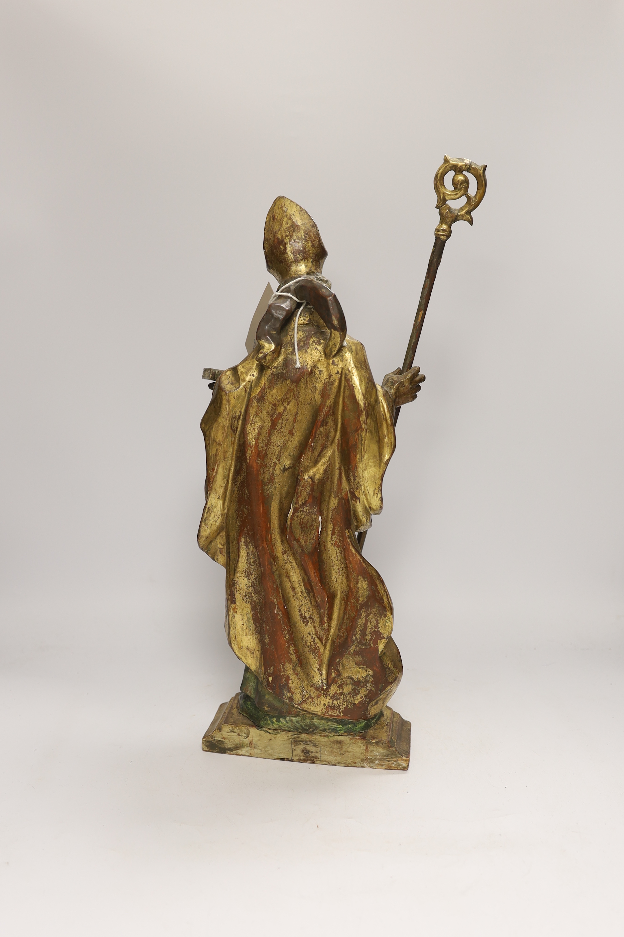 An Italian or Austrian carved gilt painted statue of a saint with staff, 48cm high